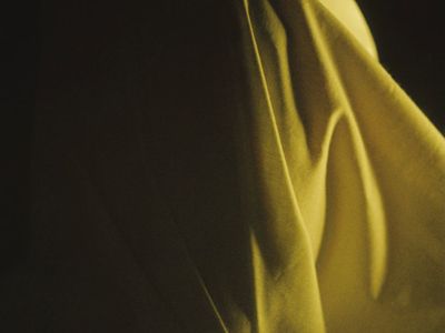 Soft waves of purple light flowing across dark surface.